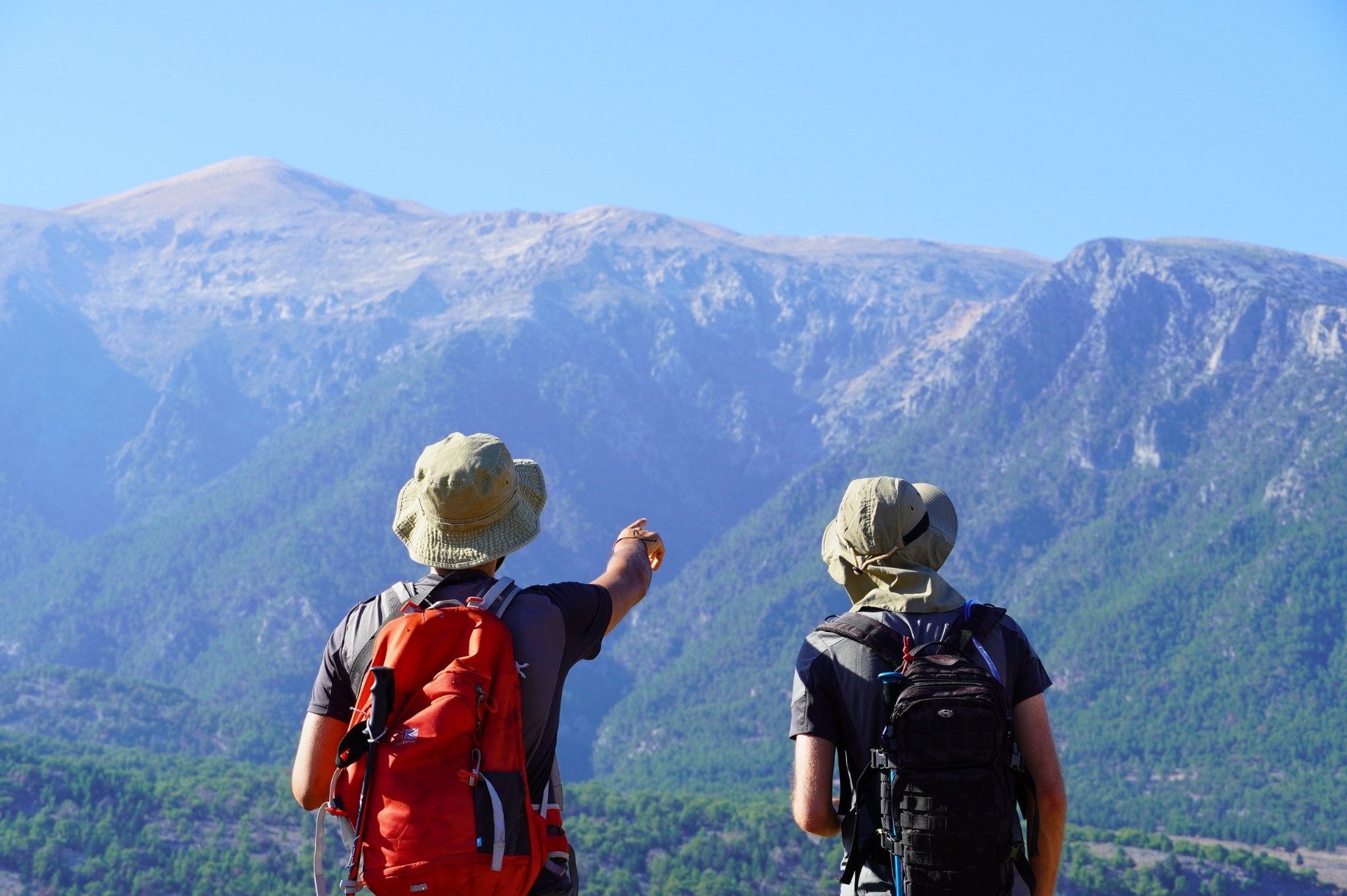 Hikers exploring the high peaks of the Lefka Ori range in summer.