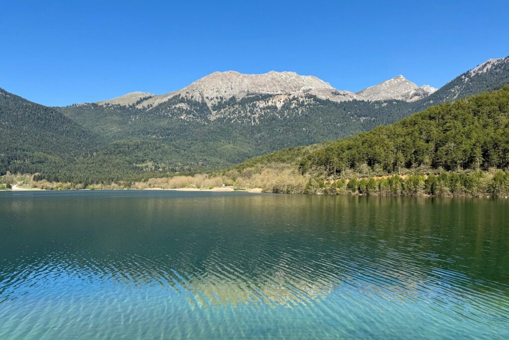 Lake Doxa in mountain Corinthia surrounded by forested peaks, Peloponnese hiking