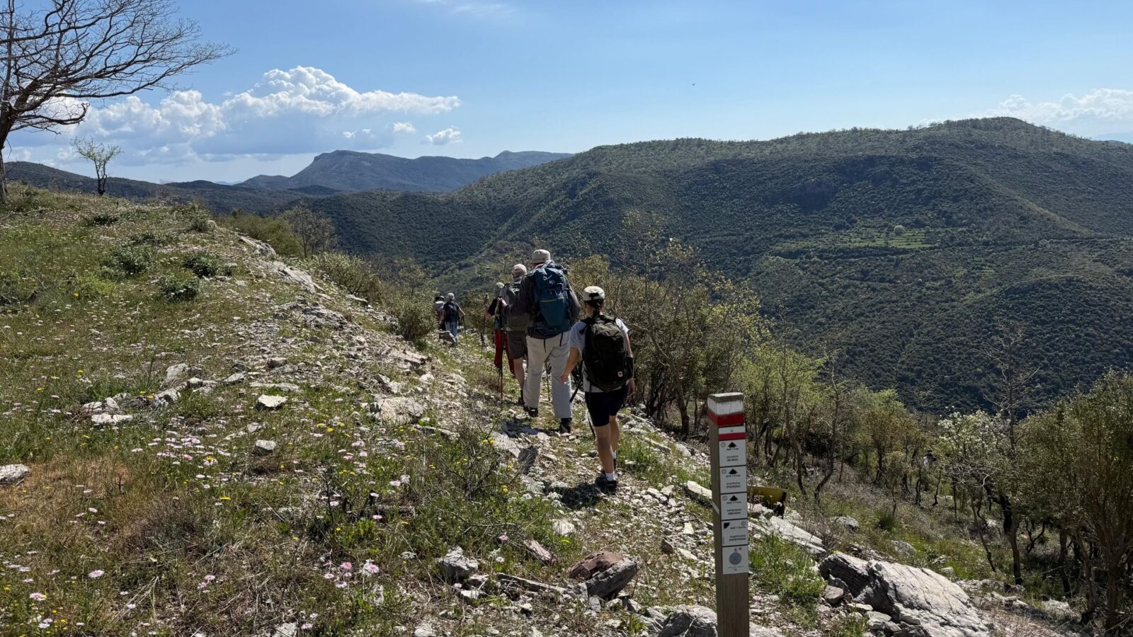 Group of hikers following a waymarked trail on a Peloponnese hillside