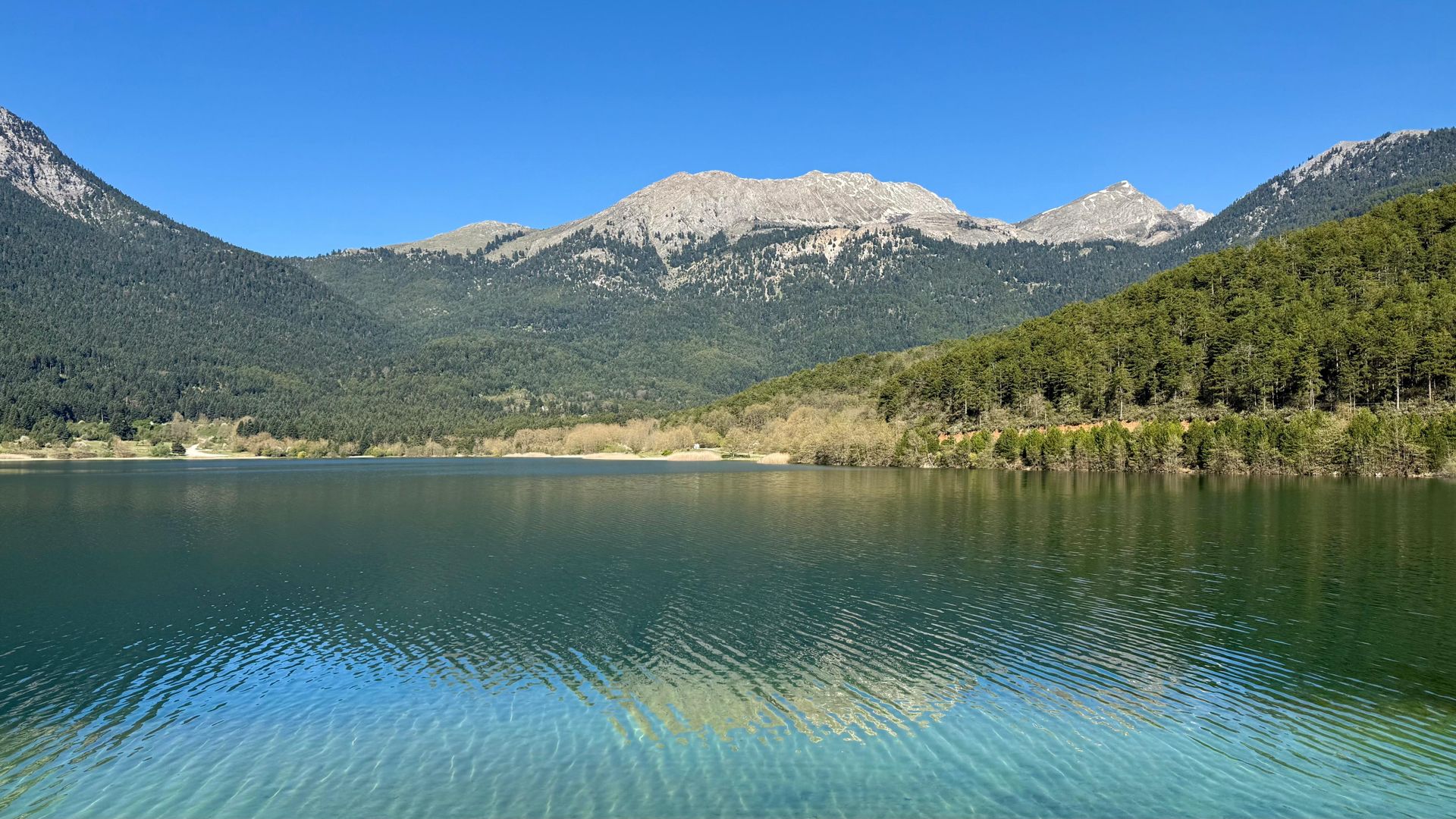 Lake Doxa in mountain Corinthia surrounded by forested peaks, Peloponnese hiking