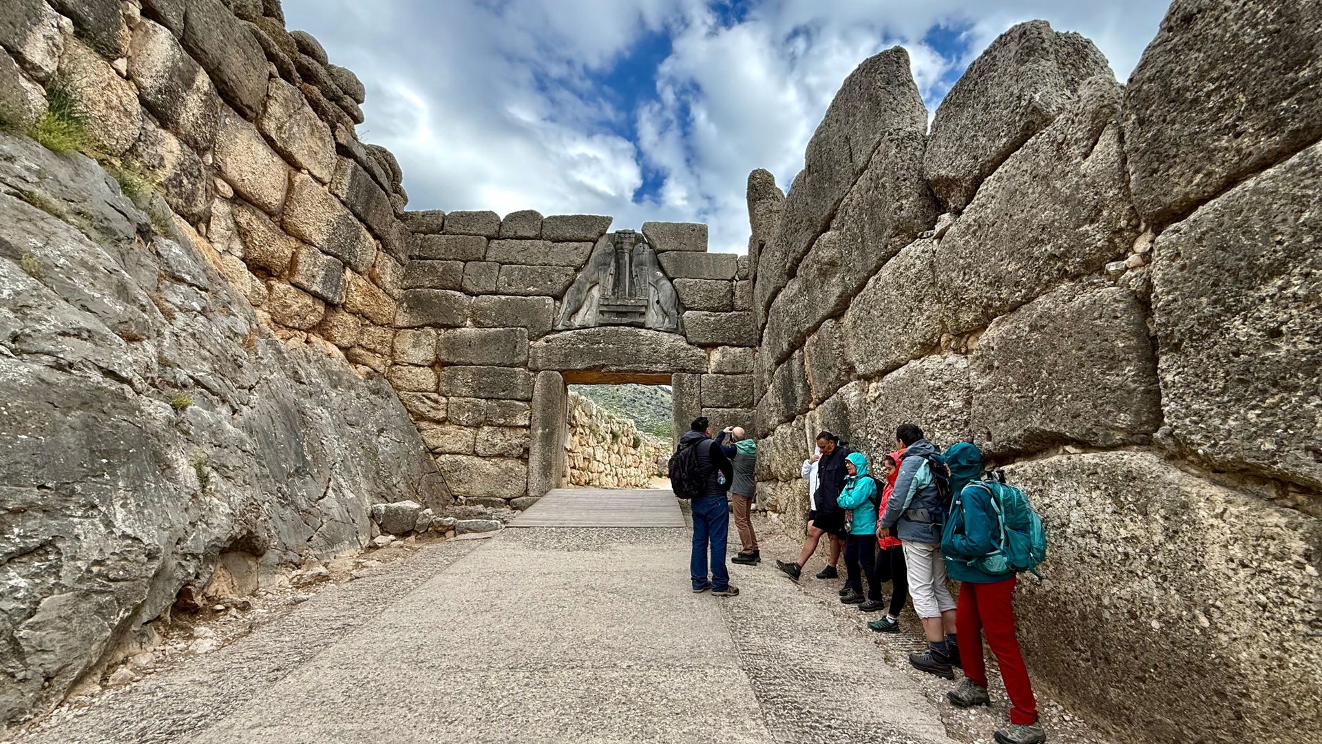 Hikers walking through the Lion Gate at Mycenae, Peloponnese